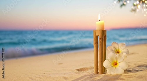 A serene beach scene with a candle and flowers