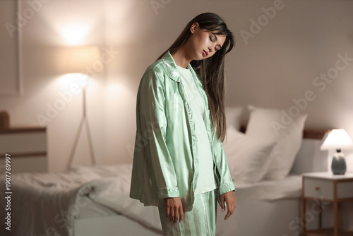 Foto Female sleepwalker near bed in evening at home
