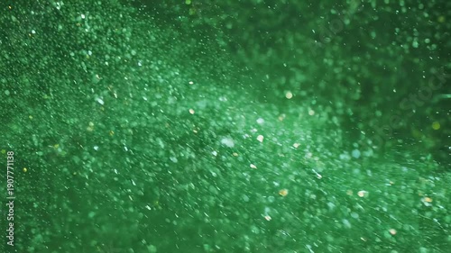 Emerald-toned abstract featuring shimmering particles and bokeh effect