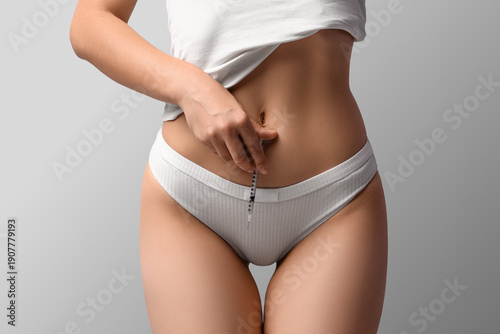Young woman with syringe on...