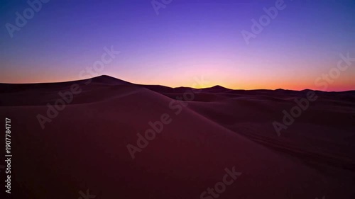 Timelapse of sunset over desert sand dunes with dramatic clouds