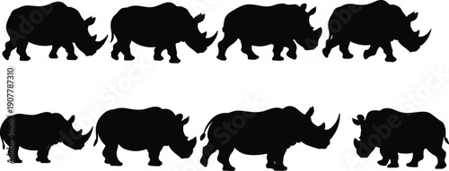 Black rhinoceros silhouettes set group of rhino walking icons isolated on white background for safari animal wildlife conservation and african nature design concept