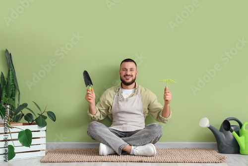 Male gardener with tools si...