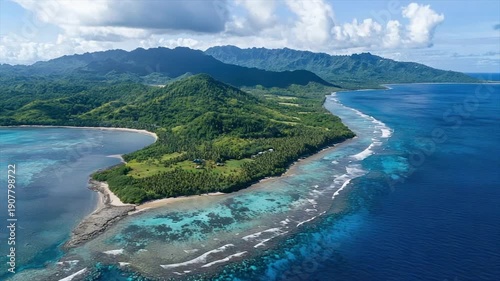 Aerial view of a tropical island coast with mountains, lush vegetation, and clear water