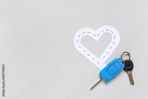 Car keys with paper road in...