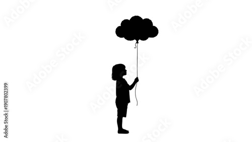 Silhouette of a young child holding a cloud shaped balloon