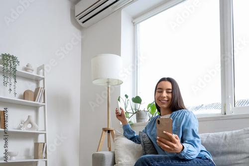 Young woman with mobile pho...