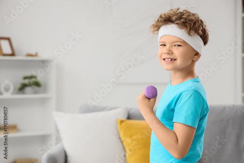 Sporty little boy exercisin...
