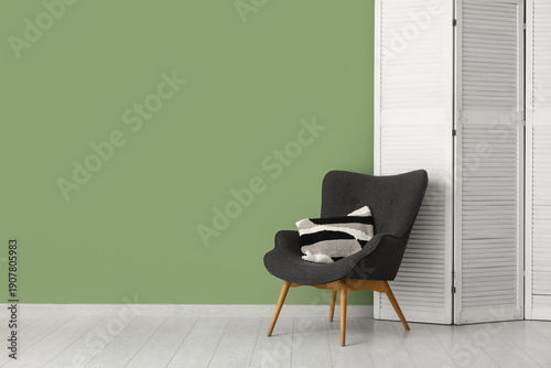 Obraz na plátne Folding screen and chair near green wall in room