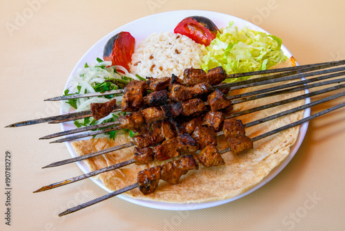 Famous Urfa meat liver, ciger wrapped by lavash with roasted chili pepper, onion and sauce in Sanliurfa, Turkey. Izgara kuzu et sis ciger. Izgara dana bonfile, cop sis, kuzu pirzola. Karisik kebap.