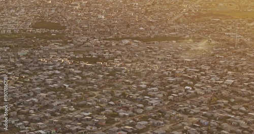 Cape Town South Africa Aerial v104 zoomed birds eye view flyover Khayelitsha township capturing vast informal settlements and view of False Bay at sunset - Shot with Mavic 3 Pro Cine - Jan 11th 2024