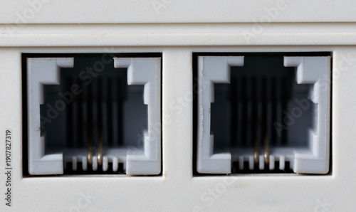 Konstfotografi Two white telephone jacks with a white cord
