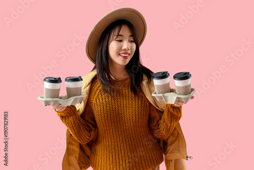 Young Asian woman with cups...