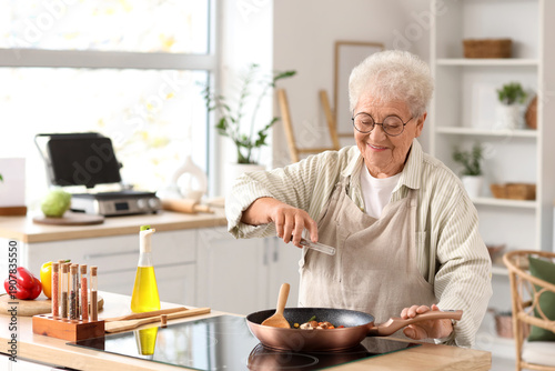 Senior woman spicing fried ...