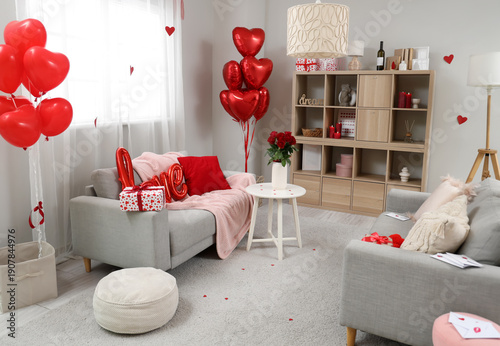 Interior of living room decorated for Valentine's Day with sofas, shelf unit and balloons