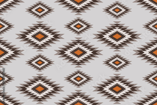 Seamless tribal geometric pattern with earthy brown, beige and cream tones. Inspired by native southwestern textile art, repeating diamond motifs create a warm rustic background for fabric, decor