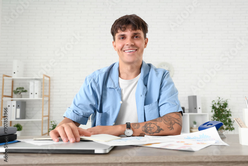 Young man working at desk i...