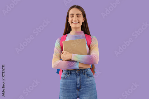 Happy female student with b...