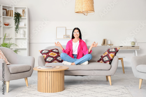 Young woman meditating on s...