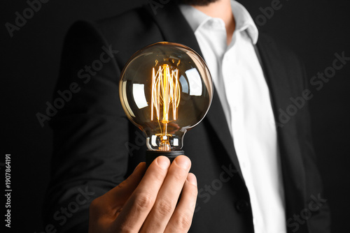 Businessman holding glowing...