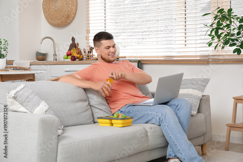 Young man with laptop and l...