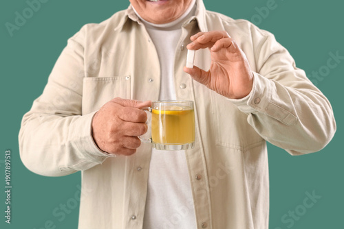 Mature man with glass cup o...