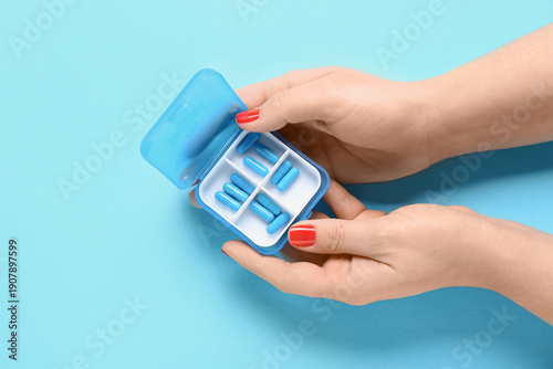 Female hands and container ...