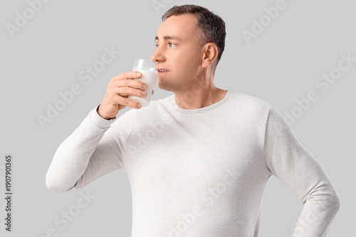 Mature man drinking milk on...