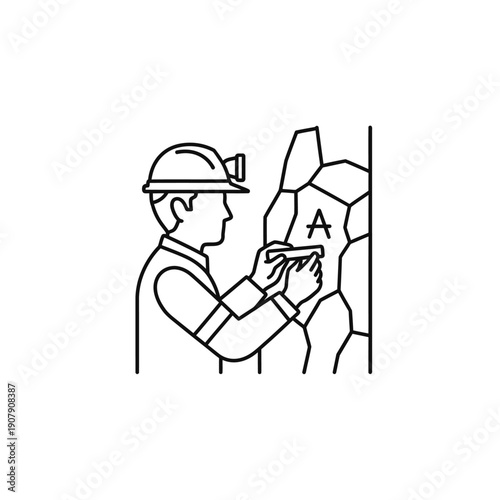 Geologist miner with headlamp inspecting underground rock wall markings