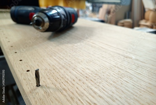 broken wood drill bit during drilling. broken tool. inexperienced worker. poor quality of material. close-up. technological process. illustration.