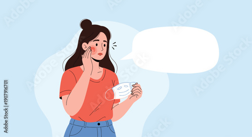 Concerned young woman looking at skin irritation on her face while holding a medical protective mask in a bathroom mirror.