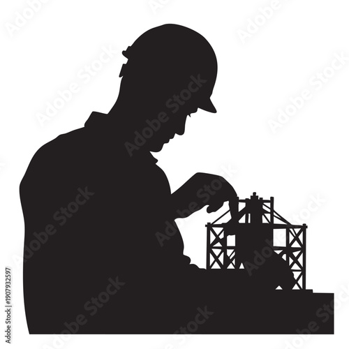 Silhouette of a male civil engineer wearing a hard hat and working on a construction project model.