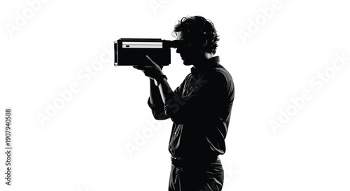 Silhouette of a filmmaker carefully looking through the viewfinder of a vintage movie camera