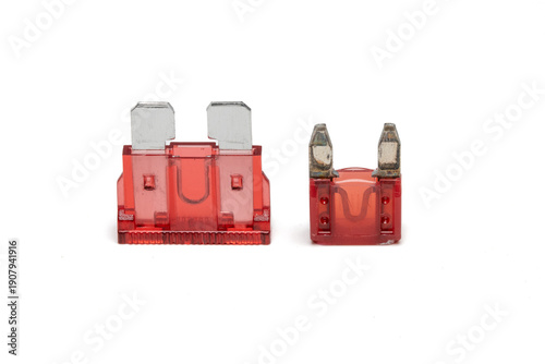 close up shot of a regular and mini type automotive fuse. showing it's difference in size. isolated on white background.