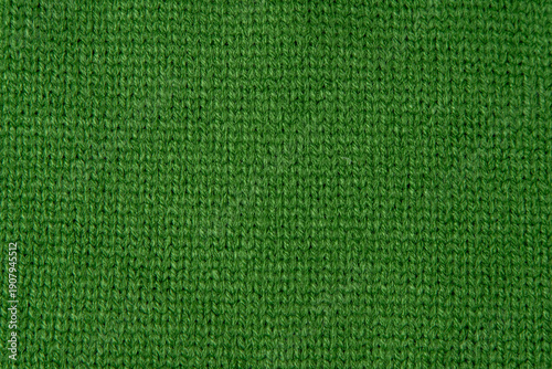 Green Knit Fabric wool sweater texture background. Knitwear woolen textile
