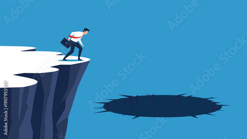 Businessman with a briefcase stands cautiously at the edge of a cliff looking down at a giant dark hole of risk.