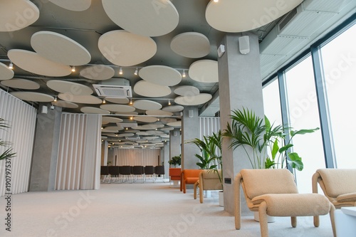 Фотография Modern office lounge interior with hanging acoustic panels