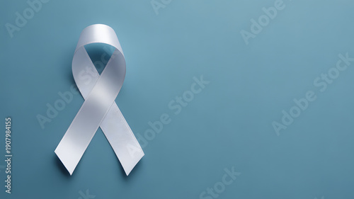 White awareness ribbon on blue background symbolizing support and hope for a cause