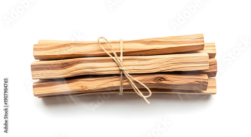 A bundle of aromatic Palo Santo wood sticks tied with natural twine on a white background.