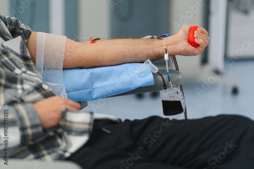 Fotografie Blood donor giving blood for medical transfusion