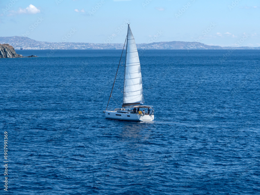 Fototapeta premium Beautiful yacht off the coast of Mykonos in the Aegean Sea in Greece