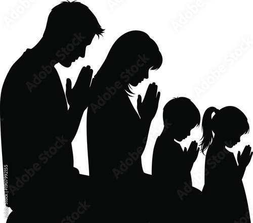 A family of four kneeling together in prayer with their heads bowed.