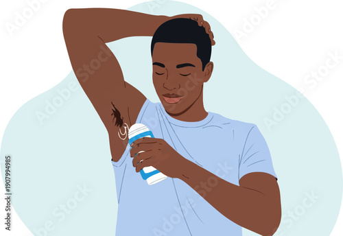 Young man applying deodorant spray under his armpit