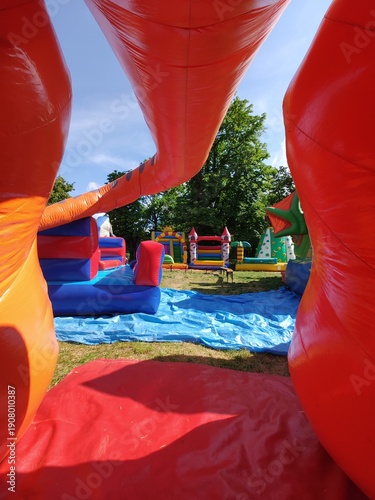 Colorful inflatable attractions providing fun and entertainment for children and adults at outdoor events.