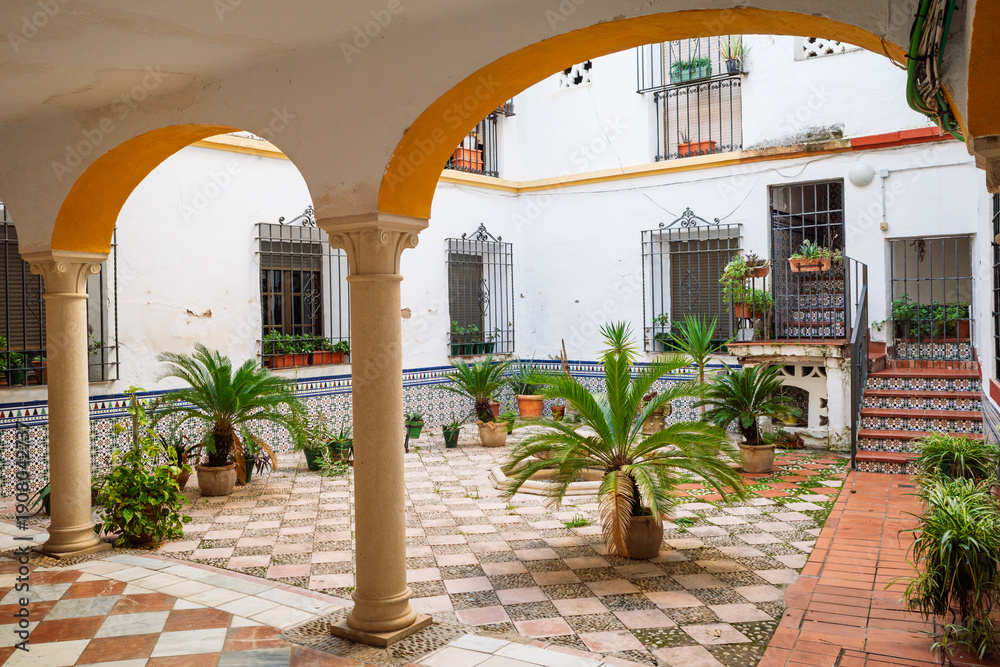 Fototapeta premium Typical Andalusian Patio with Traditional Arches and Potted Plants, Cordoba, Spain