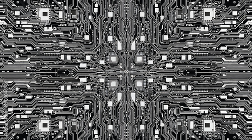 A black and white image of a circuit board with many wires and microchips
