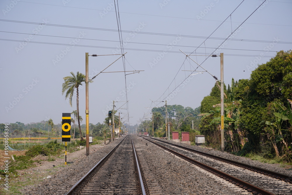 Fototapeta premium Straight Railway Track with Signal Post and Overhead Wires