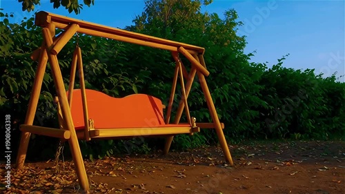 Wallpaper Mural A rustic wooden swing seat with an orange cushion, surrounded by lush greenery under a clear blue sky Torontodigital.ca