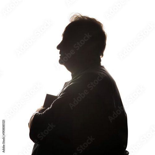 Silhouette of a Person Holding a Book Against a Bright Background in a Simple...