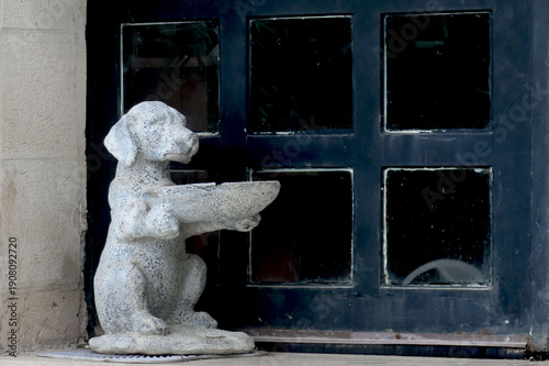 Stone statue of a dog in front of the entrance to the Wildlife Care Building in Amman